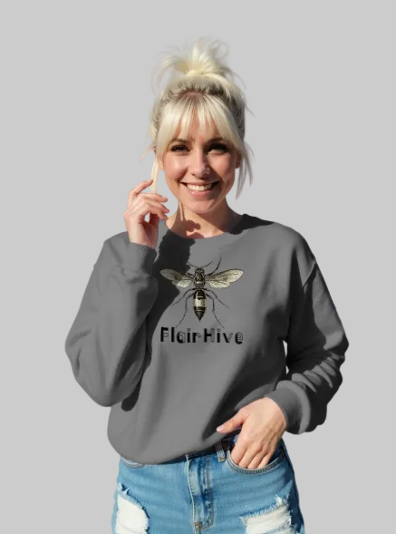 Woman wearing a sweatshirt with a bee design and 'Flair Hive' text, standing outdoors.
