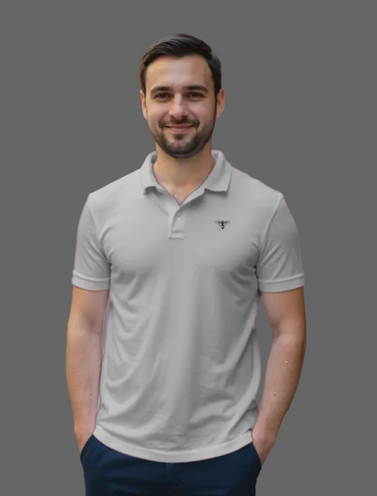 Man wearing a light gray polo shirt on a city street